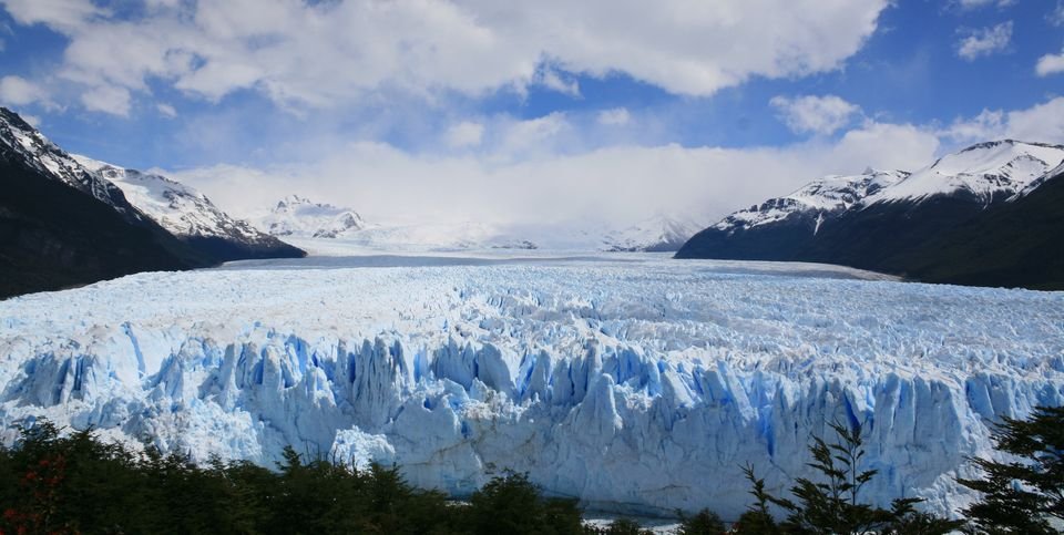The front of the Perito Moreno Glacier in Los Glaciares National Park, Santa Cruz, with snow-capped mountains